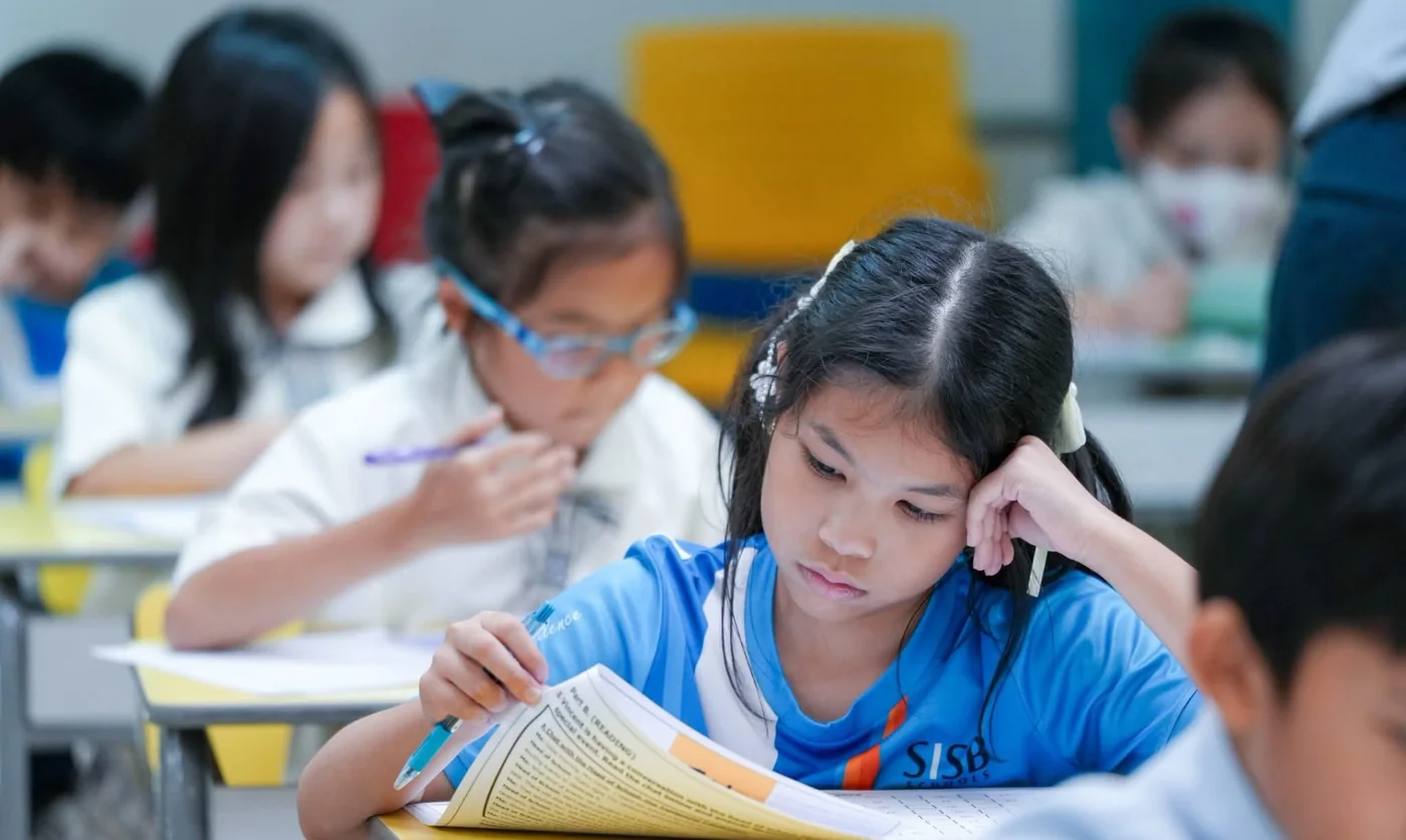 A young scholar concentrating on a question paper