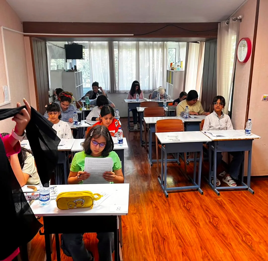 A supervised group of young scholars reading their papers