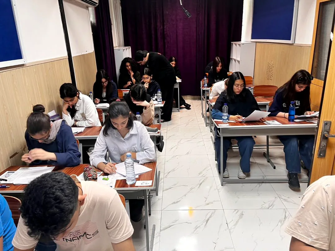 Students completing papers in a supervised classroom