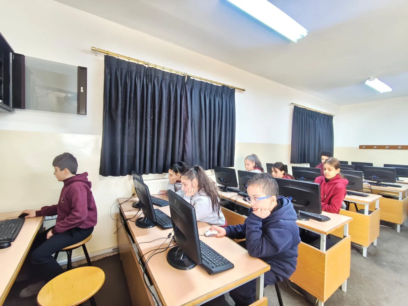 Young scholars completing a computer-based challenge