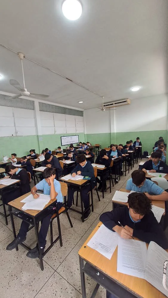 A classroom of scholars working independently at their desks